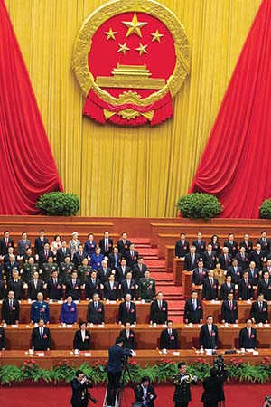 China's top leaders stand to sing the national anthem at the close of the annual National People's Congress held in Beijing's Great Hall of the People on Wednesday, March 16, 2016. (AP Photo/Ng Han Guan)